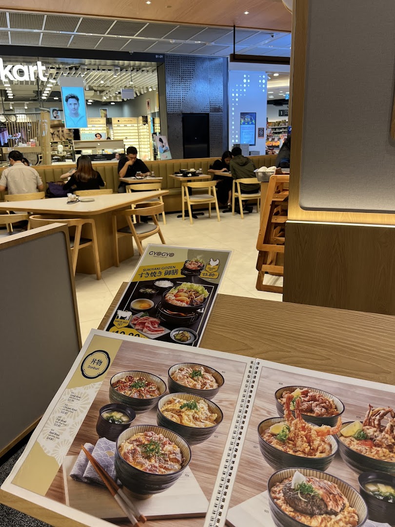 A close-up view of a Japanese restaurant's menu featuring various donburi bowls and a sukiyaki set.