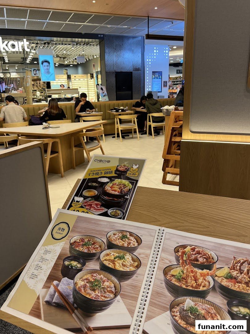 A close-up view of a Japanese restaurant's menu featuring various donburi bowls and a sukiyaki set.