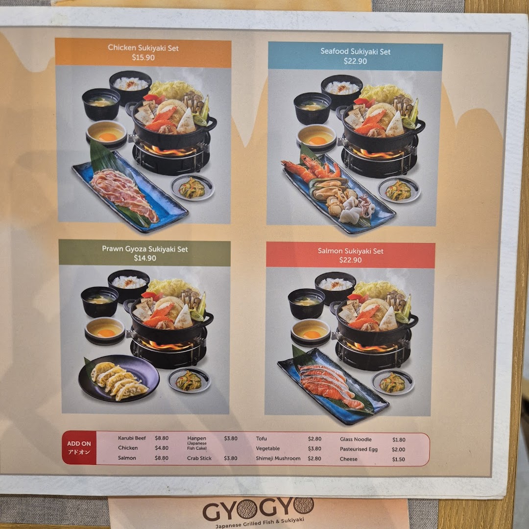 A menu board displaying various sukiyaki sets and add-on options with prices at GyoGyo.