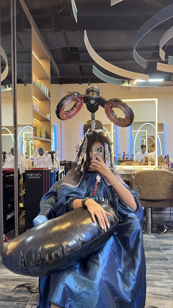 A customer receives a hair treatment with foils and a dryer at Hallyu Hair salon.