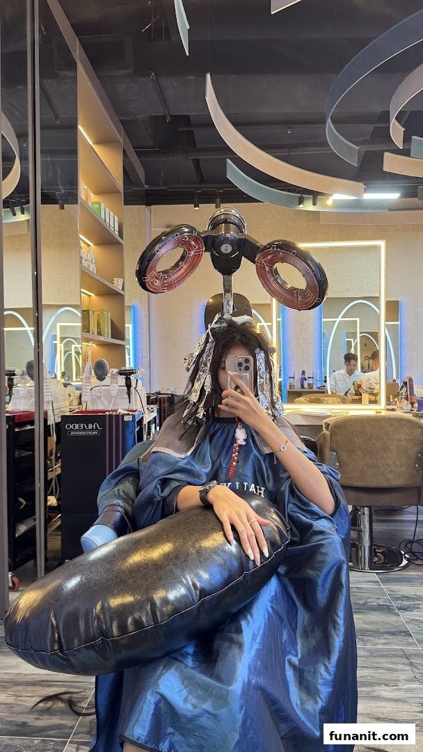 A customer receives a hair treatment with foils and a dryer at Hallyu Hair salon.