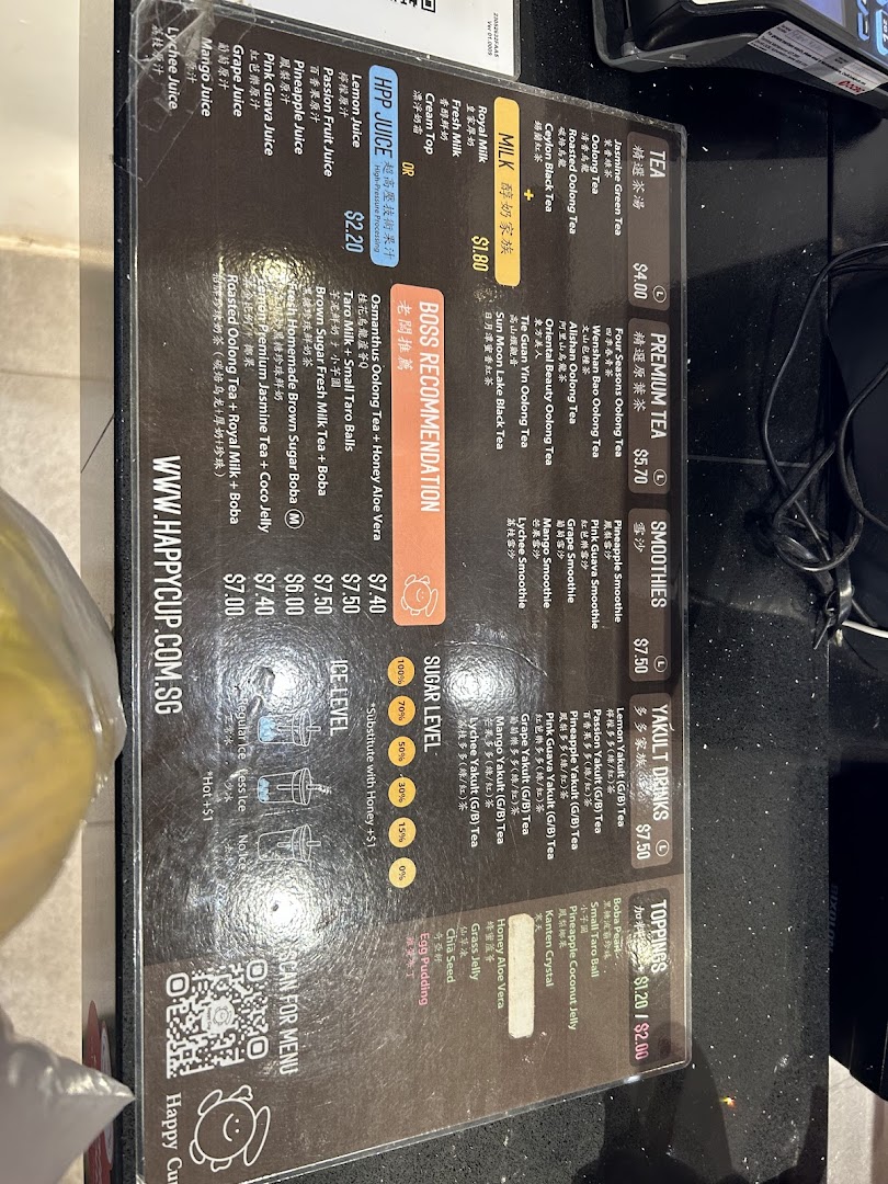 A detailed menu board displaying various tea, milk, juice, smoothie, and Yakult drinks with prices and customization options.