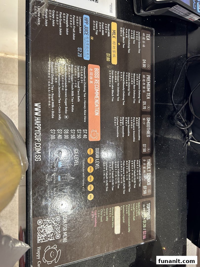 A detailed menu board displaying various tea, milk, juice, smoothie, and Yakult drinks with prices and customization options.