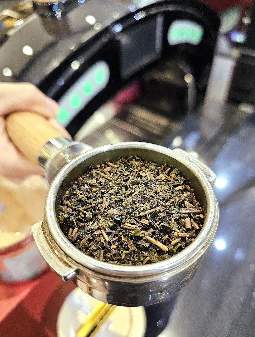 A close-up of loose leaf tea in a portafilter, ready for brewing at Happy Cup Funan.