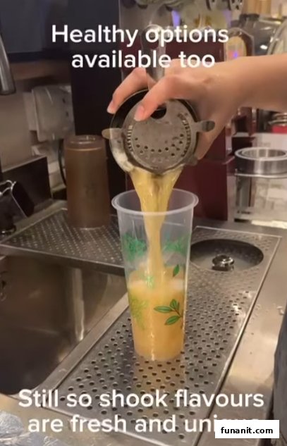 A barista pours a fresh, healthy drink into a cup at Happy Cup Funan, highlighting unique flavors.