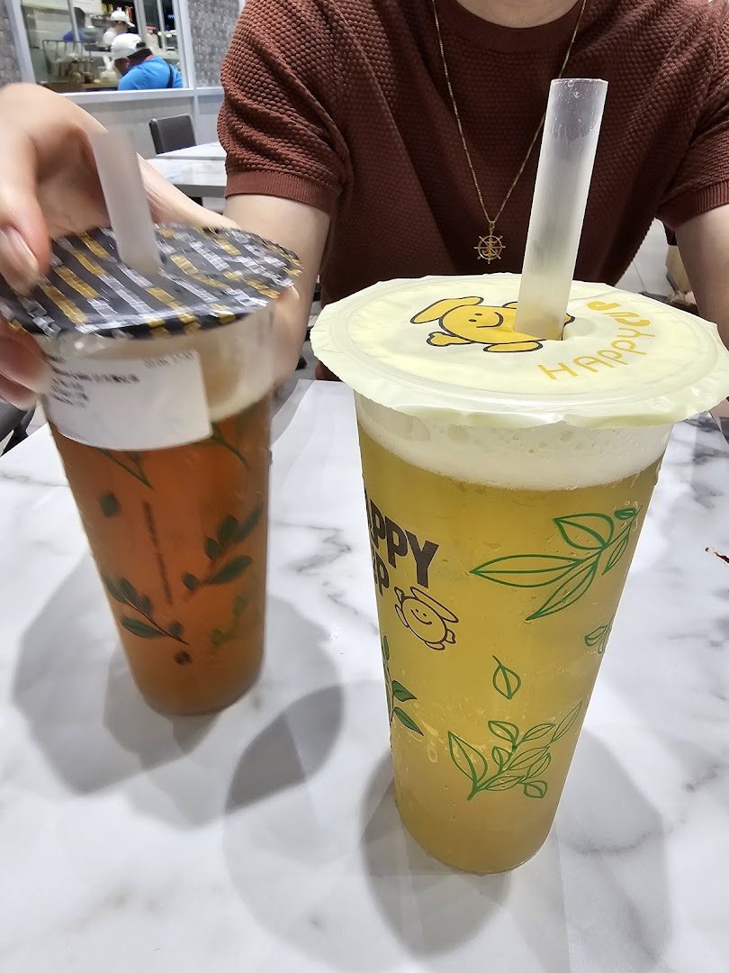Two refreshing bubble tea drinks from Happy Cup on a marble table.
