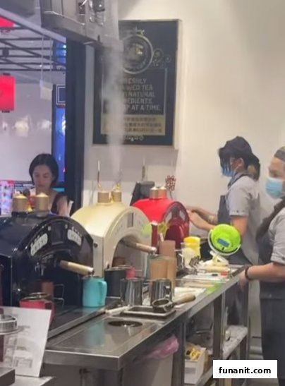 Staff prepare fresh beverages at a vibrant counter with unique tea brewing machines, showcasing the drink-making process.
