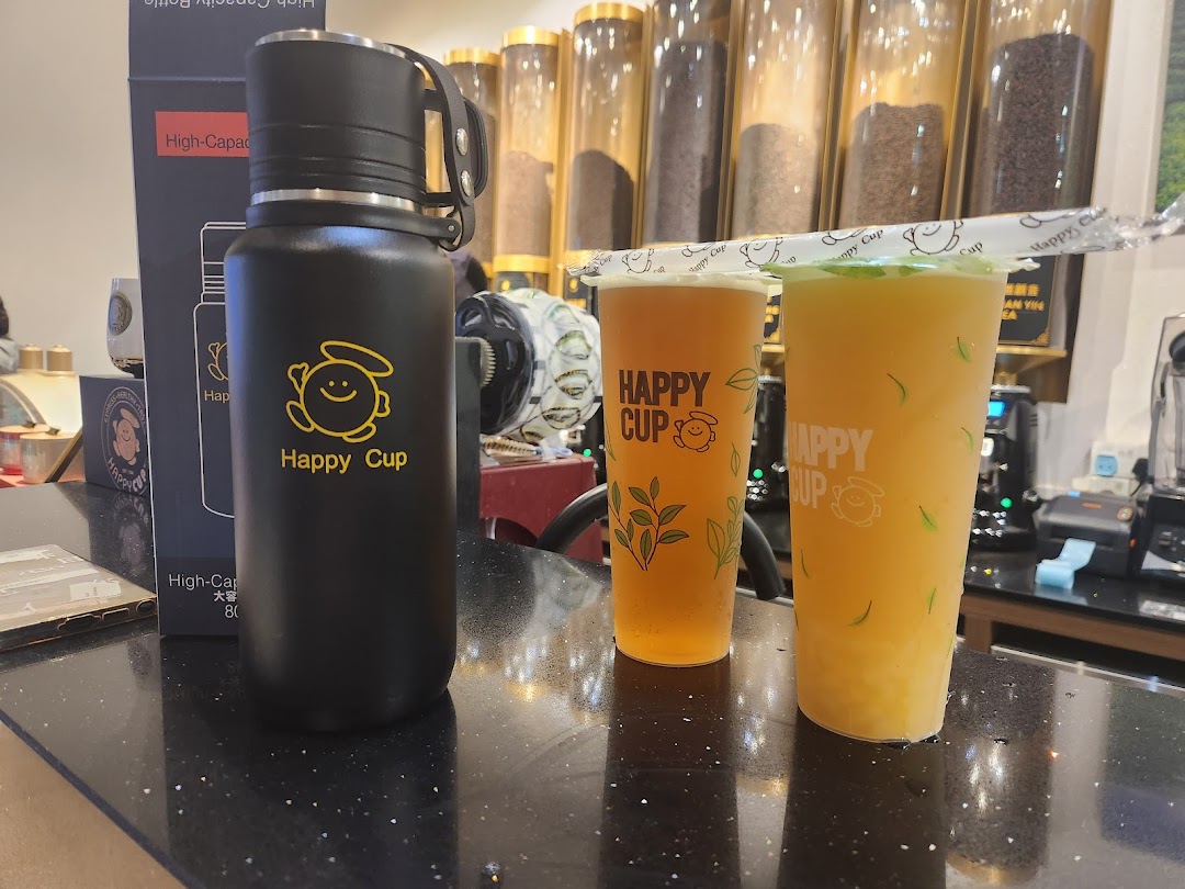Two refreshing Happy Cup beverages and a branded reusable bottle displayed on a counter.
