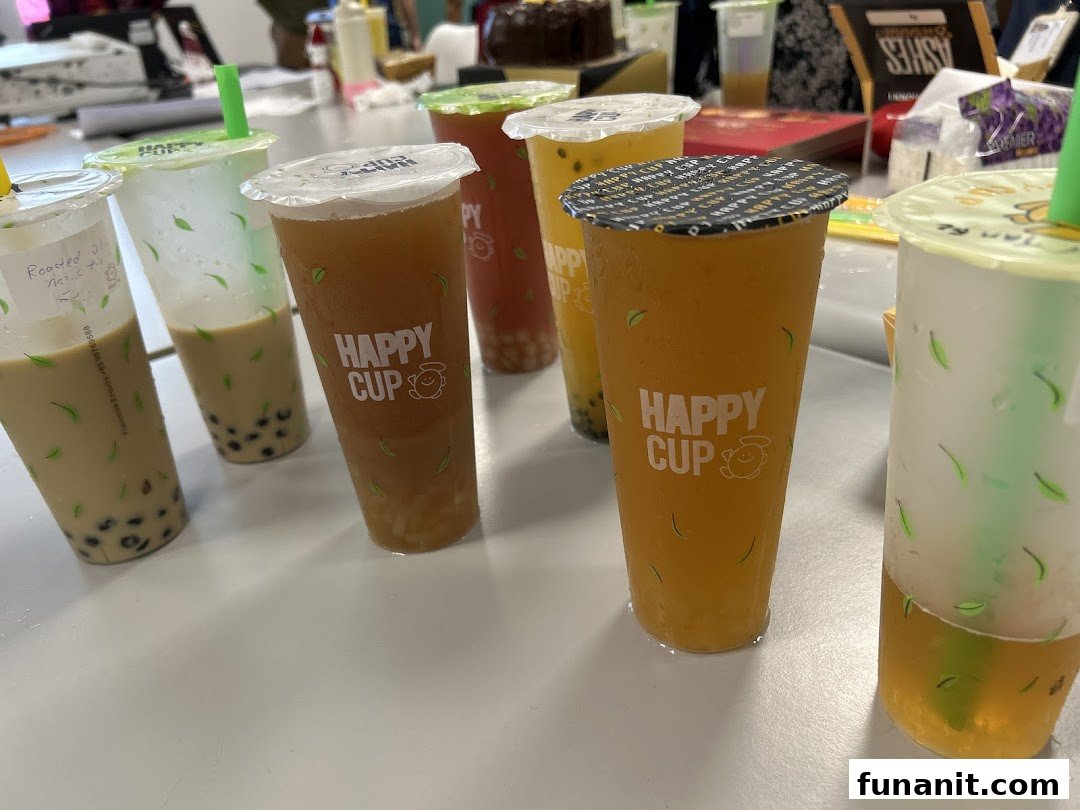 A vibrant display of various bubble tea drinks from Happy Cup, showcasing different colors and flavors.