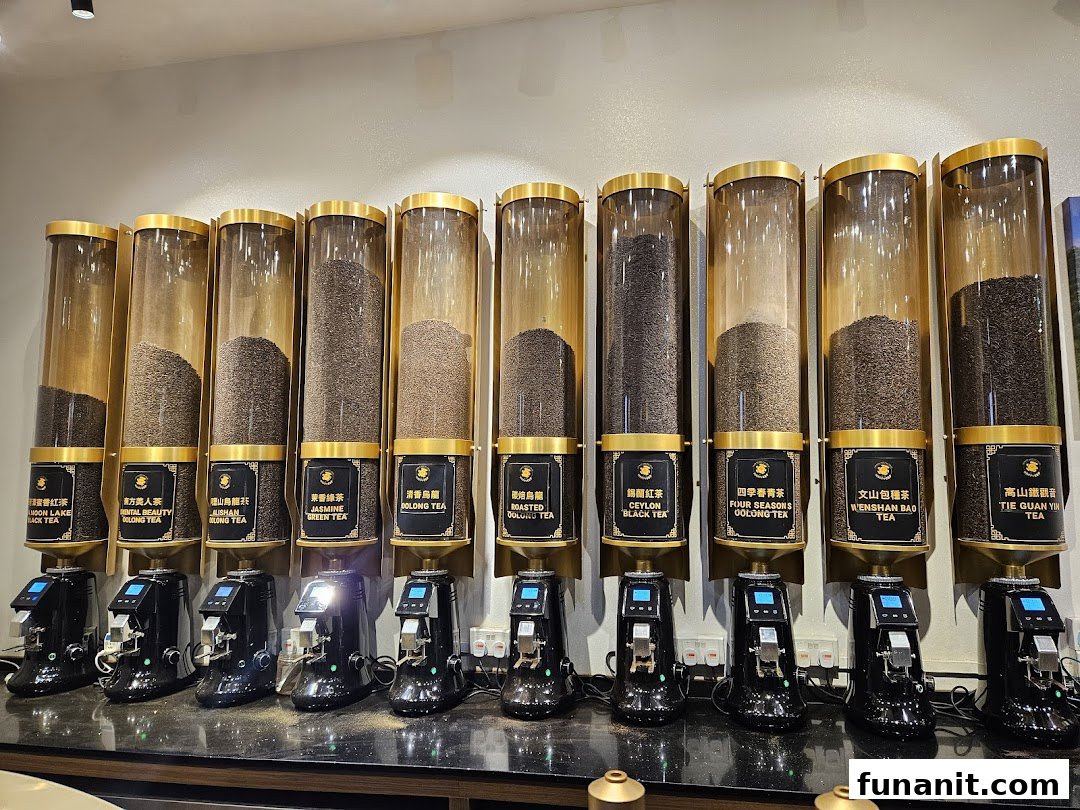 A display of various tea leaves in large dispensers with labels and dispensing machines.