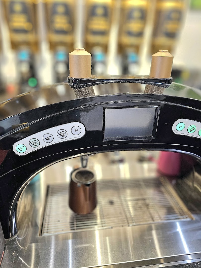 Close-up of a modern beverage dispensing machine with a small pitcher, ready to serve drinks.