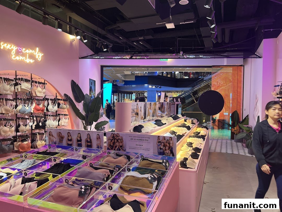 Vibrant interior of IM IN IMINXX lingerie shop showcasing bras, undergarments, and a 'sexy comfy combo' neon sign.
