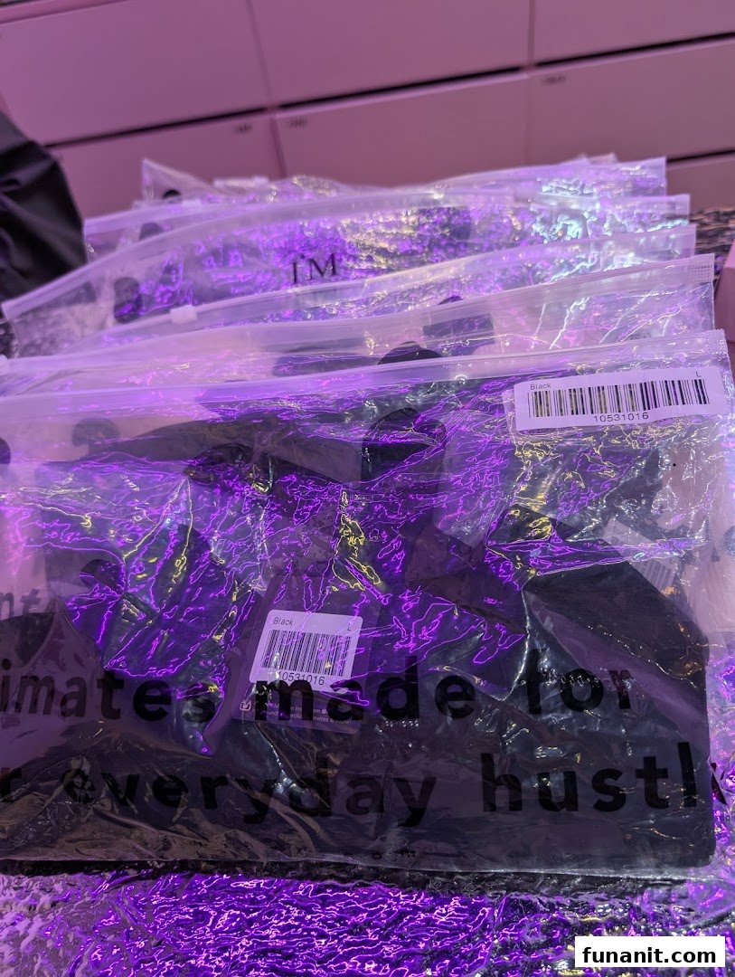 Close-up of packaged black apparel items from IM IN IMINXX, featuring 'intimates made for everyday hustle!'.