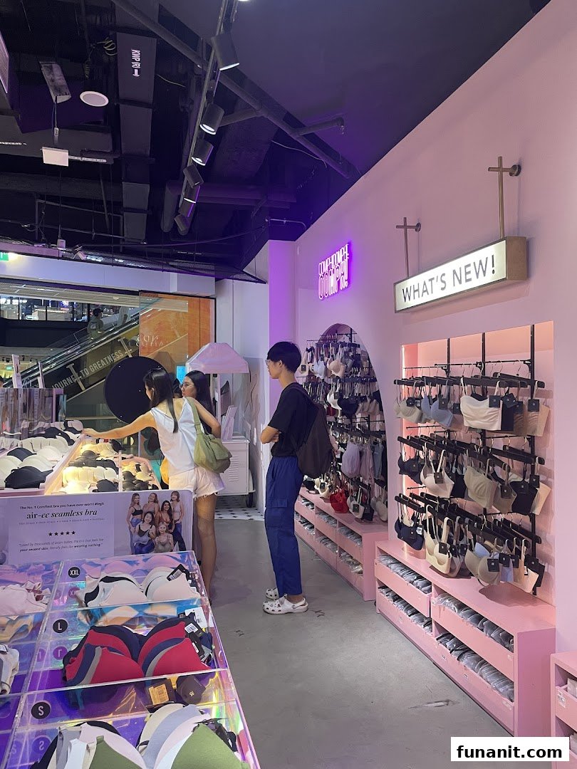 Customers browse comfortable and stylish lingerie in a modern, pink-themed shop interior.