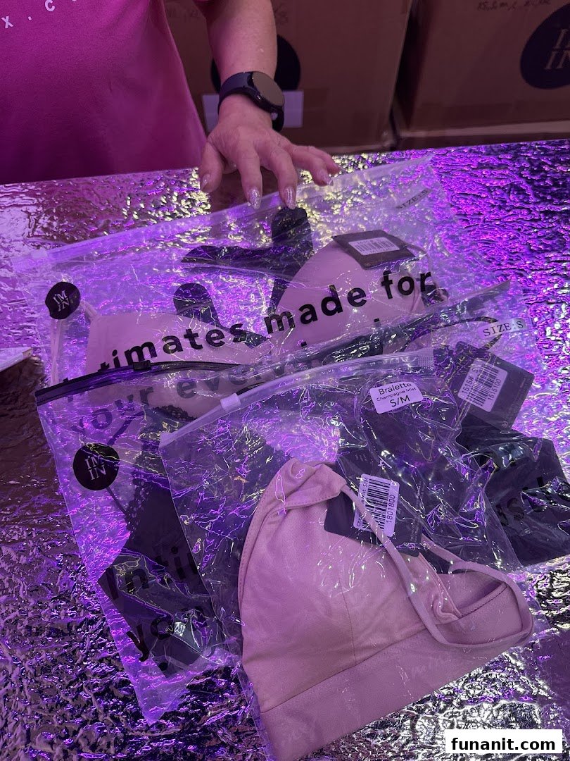 Packaged intimates and bralettes from IM IN IMINXX displayed on a reflective surface.