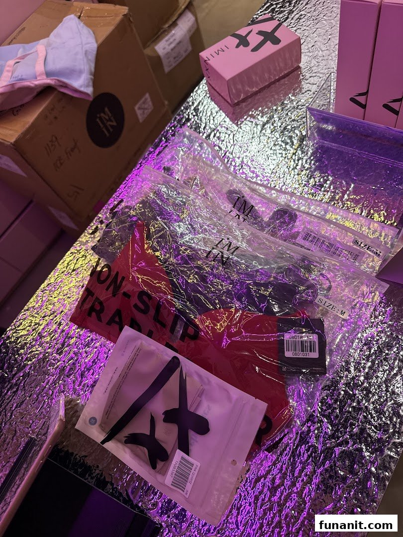 Packaged products from IM IN IMINXX displayed on a reflective surface with vibrant purple lighting.