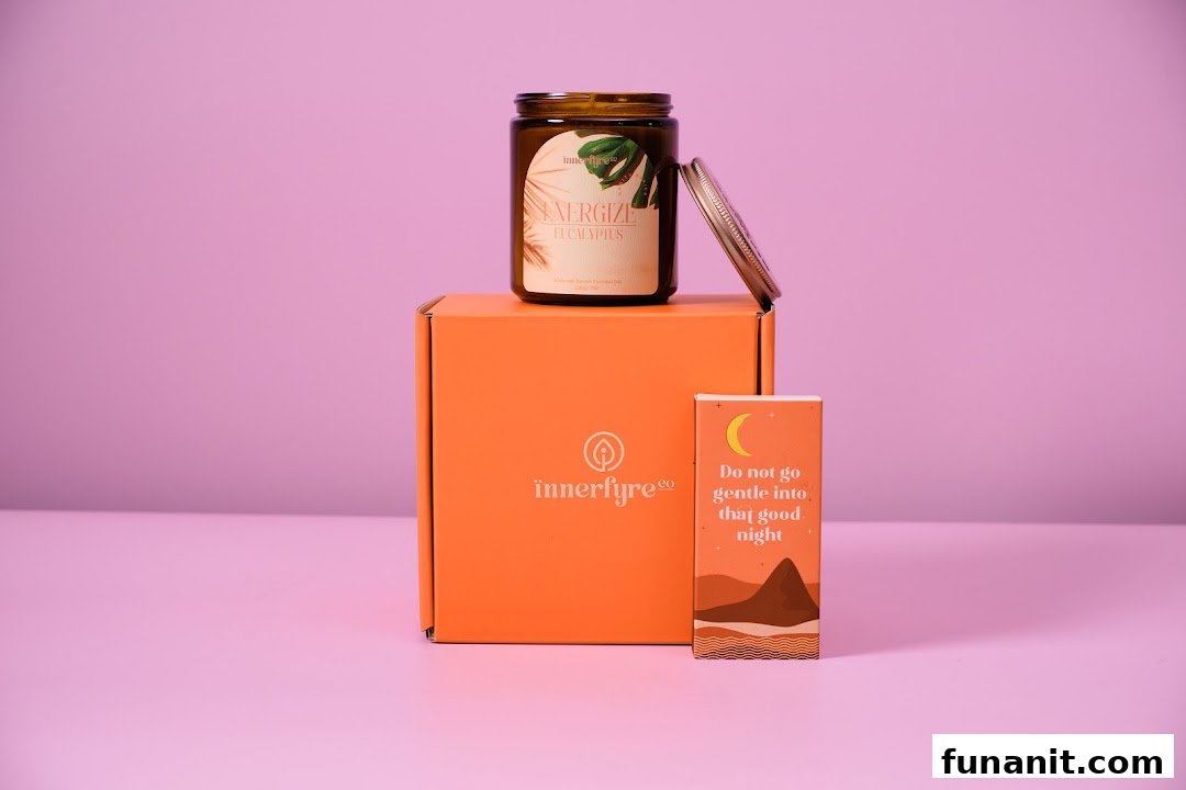 An Innerfyre Co 'Energize Eucalyptus' candle on an orange box with a decorative card.