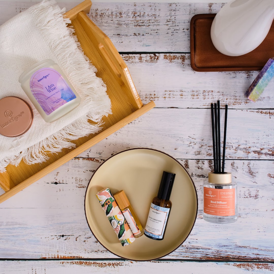 An overhead shot of Innerfyre Co's aromatherapy products, including candles, diffusers, and essential oil sprays.