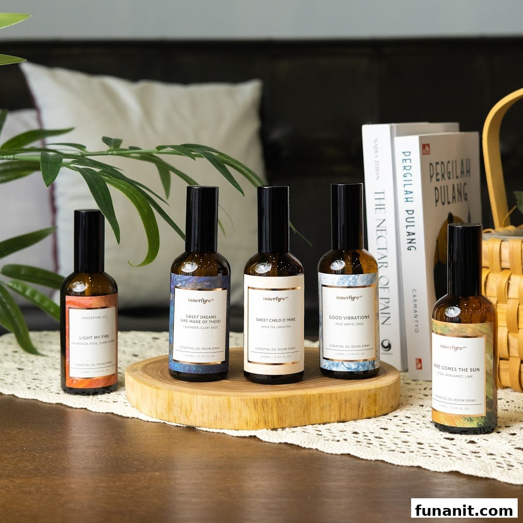 Five bottles of Innerfyre Co. essential oil room spray displayed on a wooden stand and table.