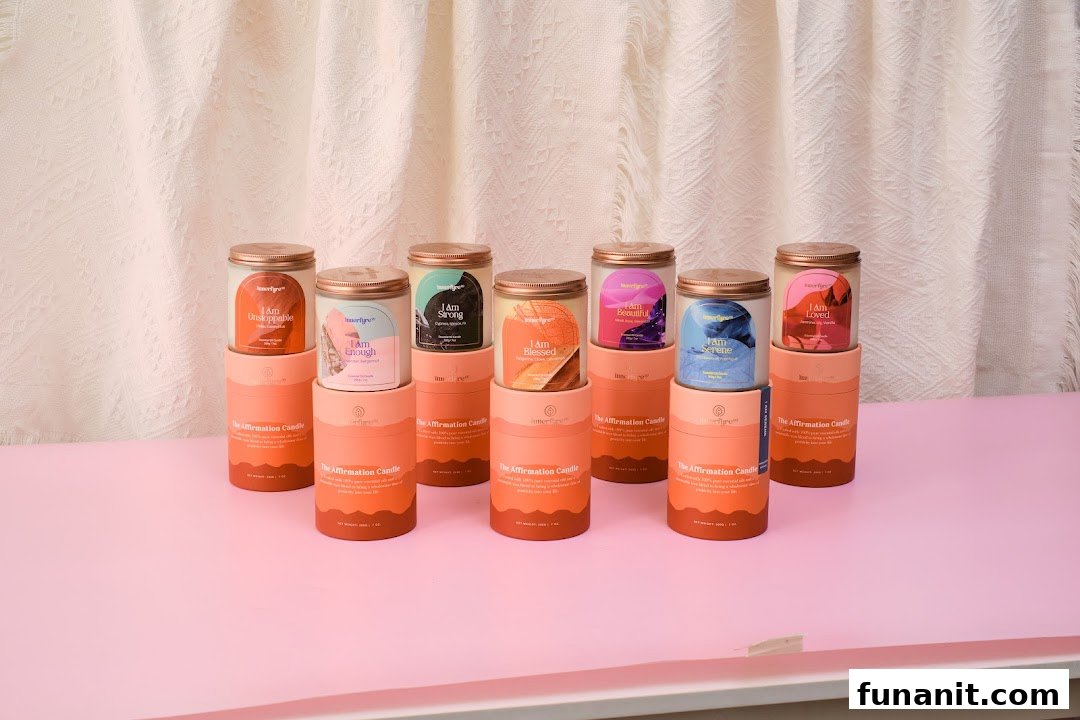 A collection of Innerfyre Co's 'The Affirmation Candle' series displayed on a pink surface.