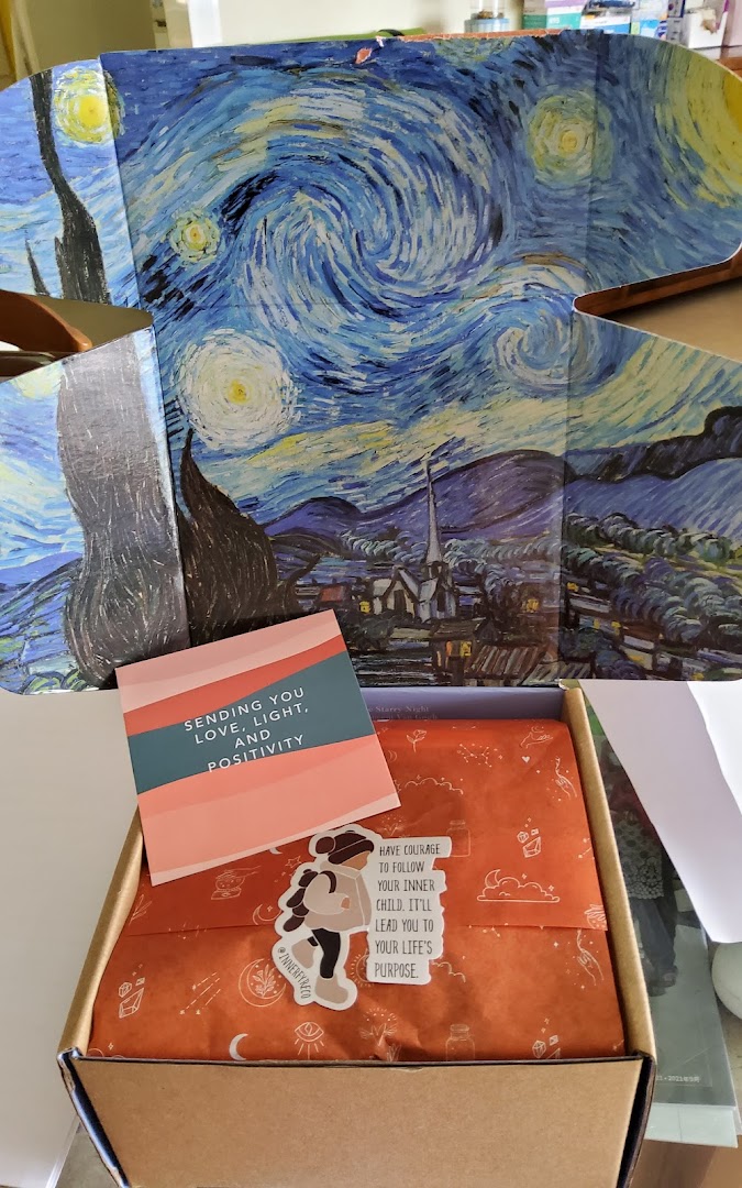 An open Innerfyre Co box with a "Starry Night" lid, a positive message card, and a sticker.