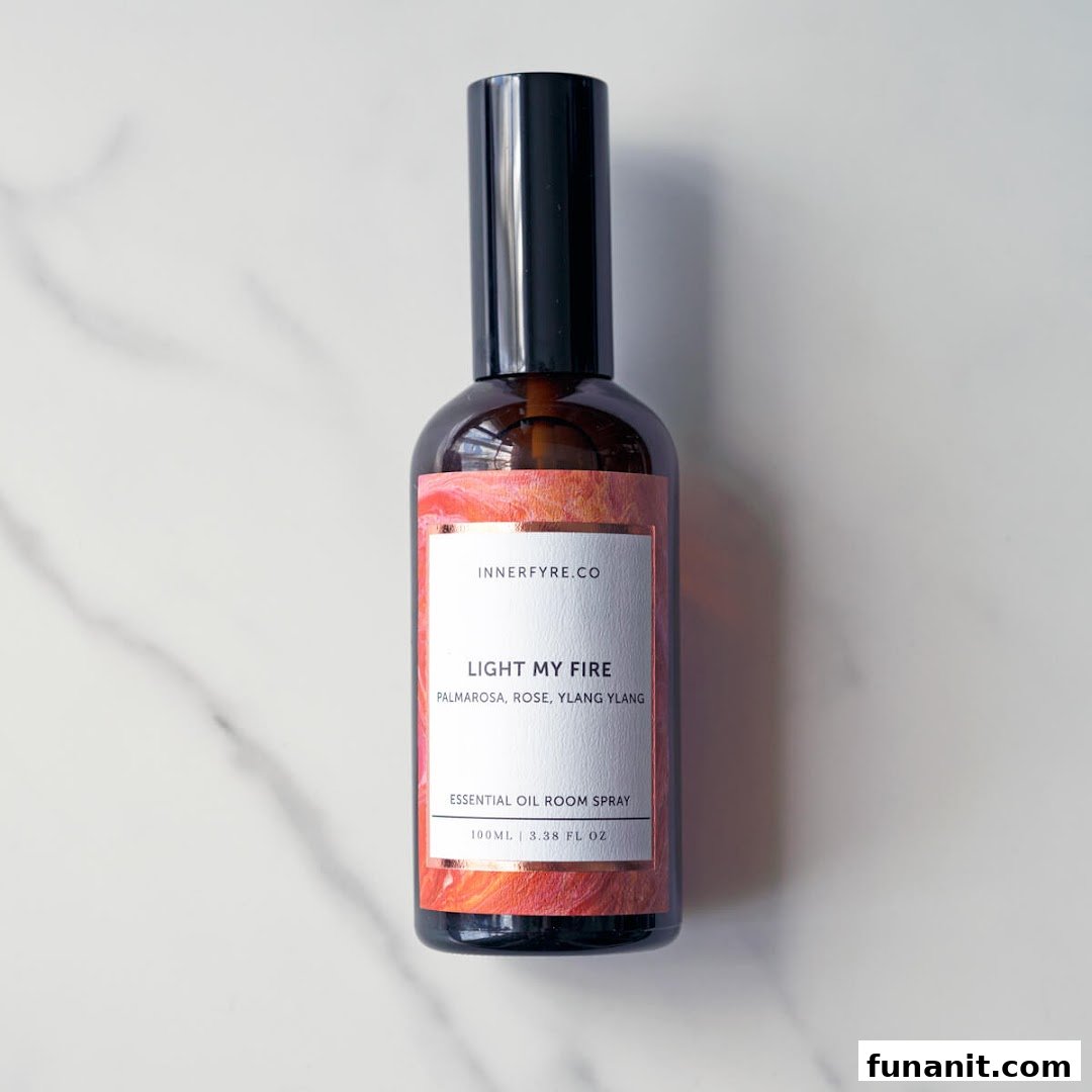 A bottle of Innerfyre Co's 'Light My Fire' essential oil room spray on a marble surface.