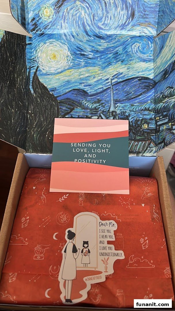 An open Innerfyre Co box revealing a Starry Night lid, a positive message card, and a product wrapped in red tissue paper.