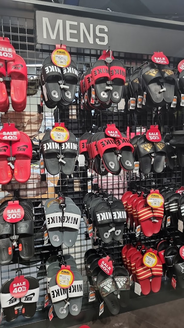A display of men's sports slides and sandals from Nike and Adidas, many on sale at JD Sports.