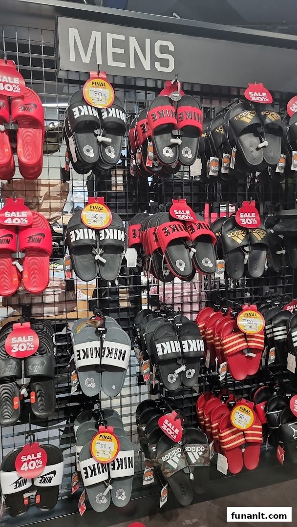 A display of men's sports slides and sandals from Nike and Adidas, many on sale at JD Sports.
