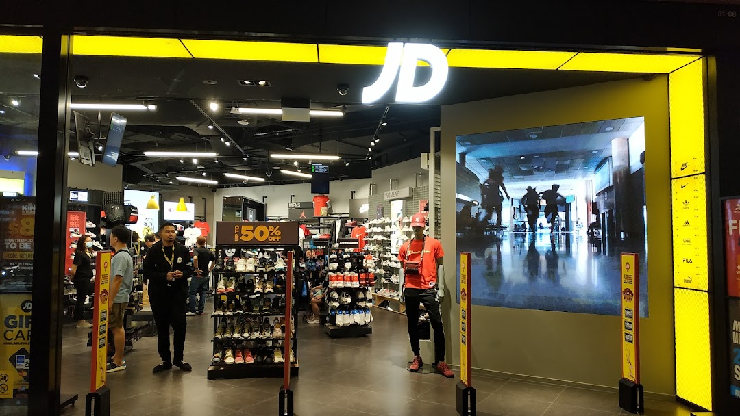 The vibrant entrance of JD Sports, showcasing athletic footwear and apparel inside.