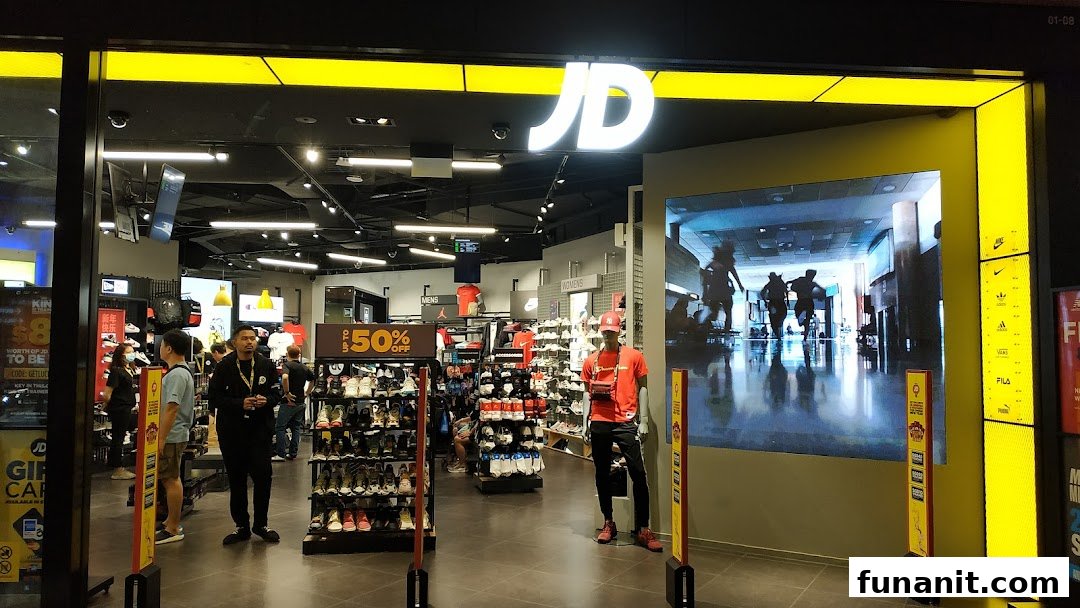 The vibrant entrance of JD Sports, showcasing athletic footwear and apparel inside.