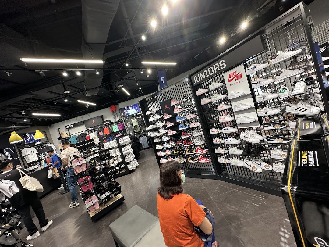 Interior view of JD Sports, showcasing a wide selection of athletic footwear and apparel for men and juniors.