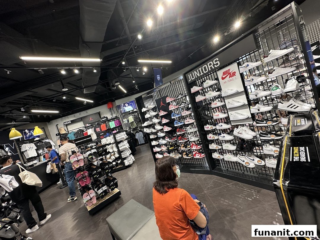 Interior view of JD Sports, showcasing a wide selection of athletic footwear and apparel for men and juniors.
