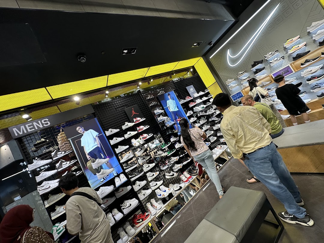Customers browse a wide selection of athletic footwear and apparel inside a JD Sports store.