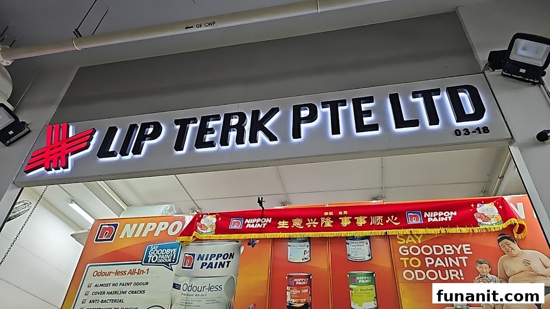 The illuminated shop sign for LIP TERK PTE LTD, featuring a Nippon Paint display.