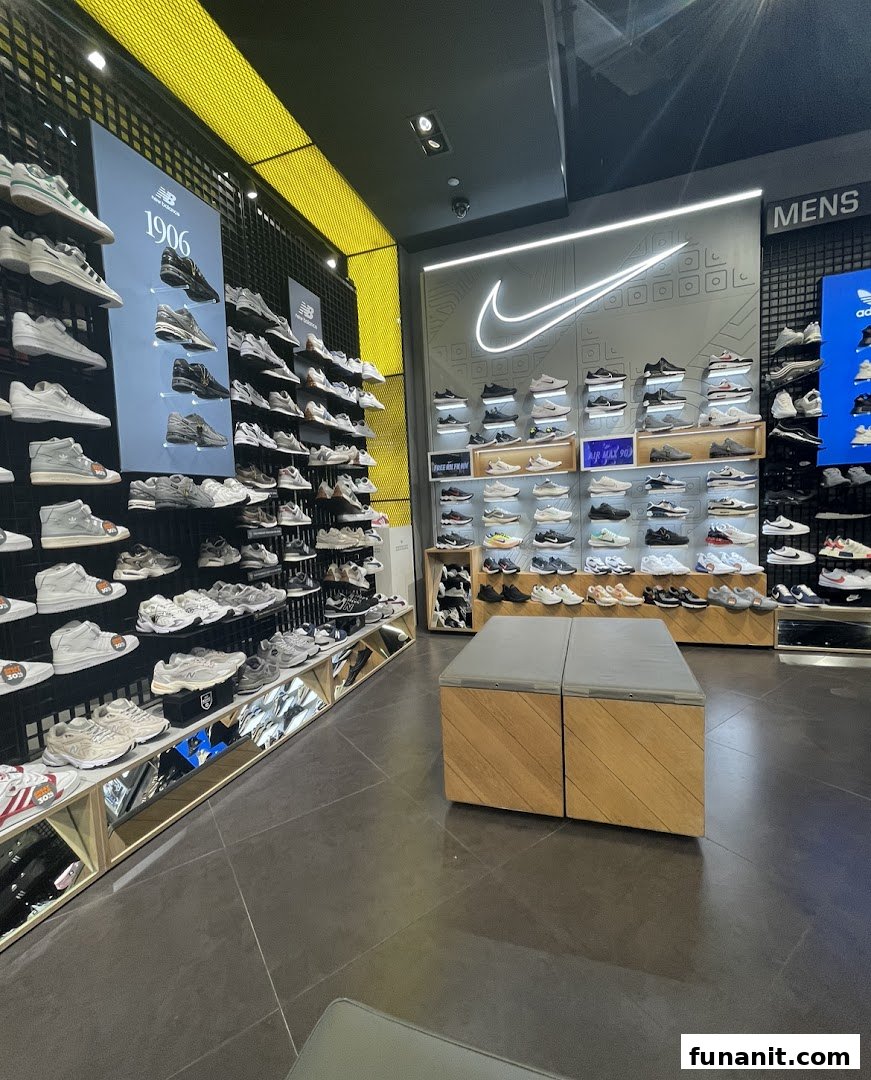 An interior view of JD Sports showcasing a wide array of athletic footwear from various brands like Nike and New Balance.