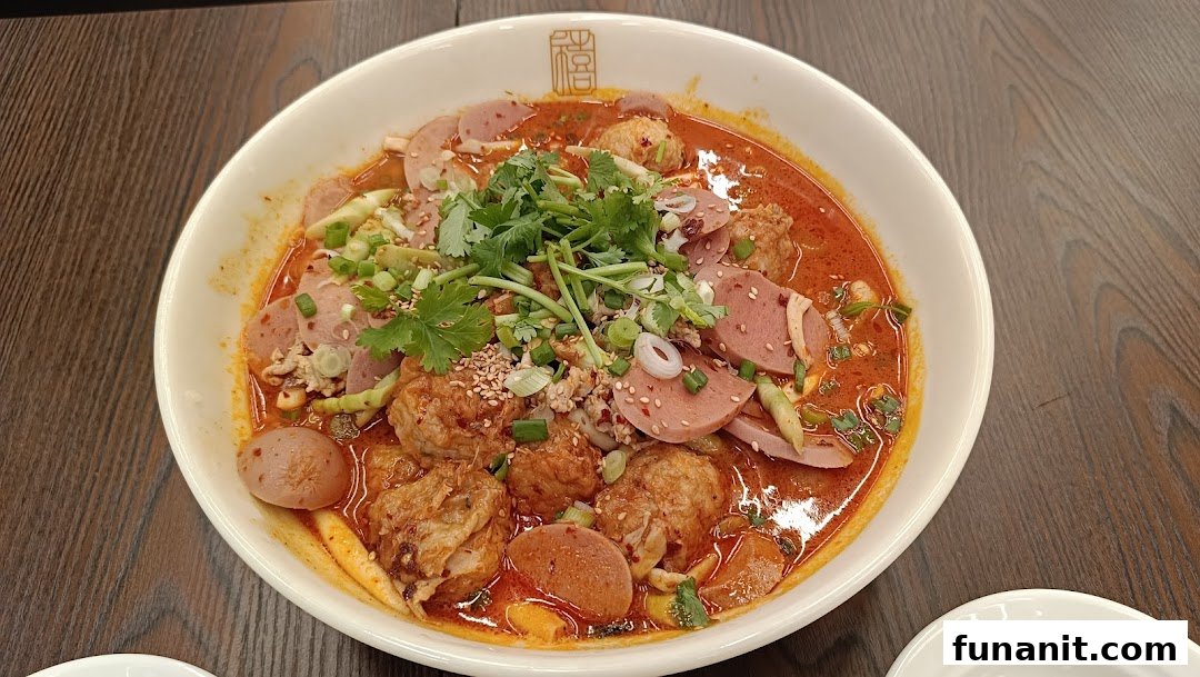 A vibrant bowl of spicy Chinese hot pot with various meats, vegetables, and broth.