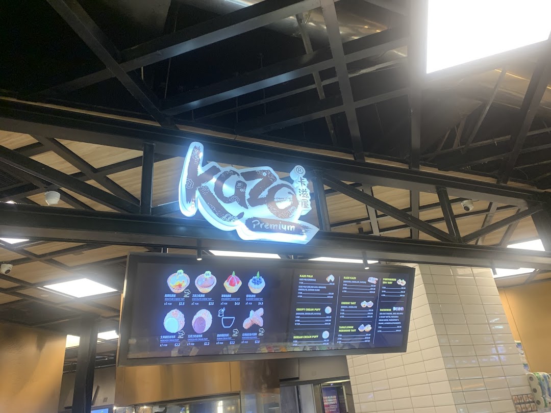 The Kazo Premium shop sign and a digital menu board displaying various cream puffs and pastries.