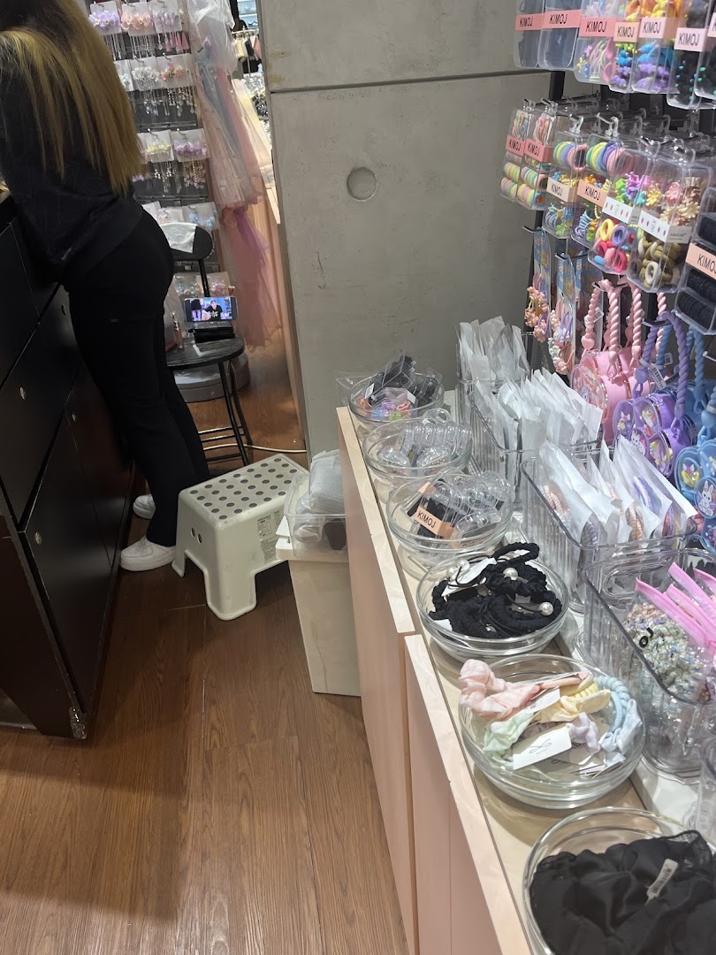 An interior view of KIMOJ, showcasing various hair accessories and small items on display.