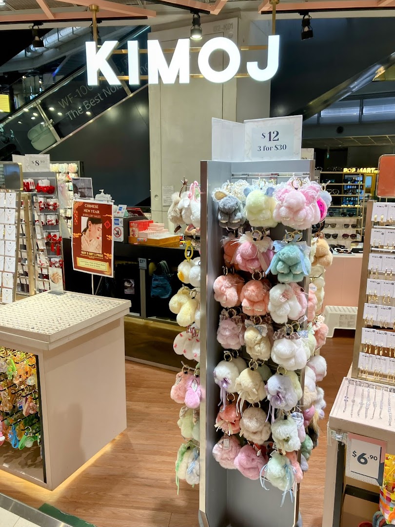 Interior view of KIMOJ shop featuring a display of colorful fluffy keychains and other accessories.