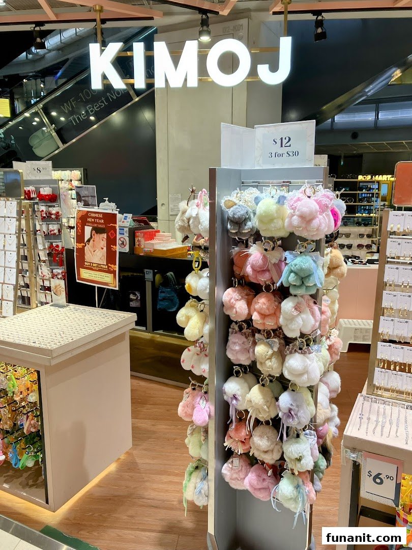 Interior view of KIMOJ shop featuring a display of colorful fluffy keychains and other accessories.