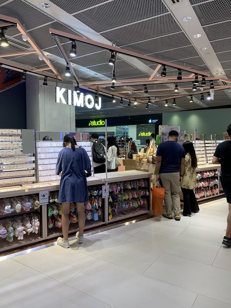 Customers browse a wide selection of accessories and keychains inside the KIMOJ retail store.