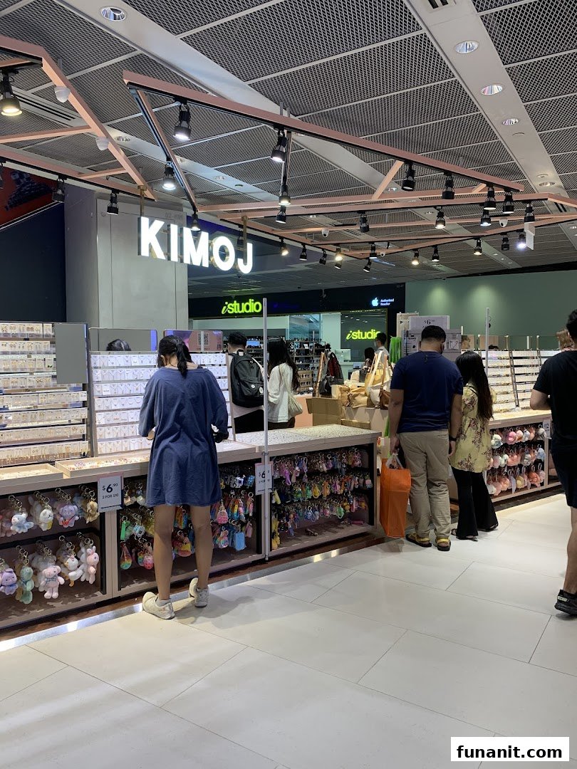 Customers browse a wide selection of accessories and keychains inside the KIMOJ retail store.