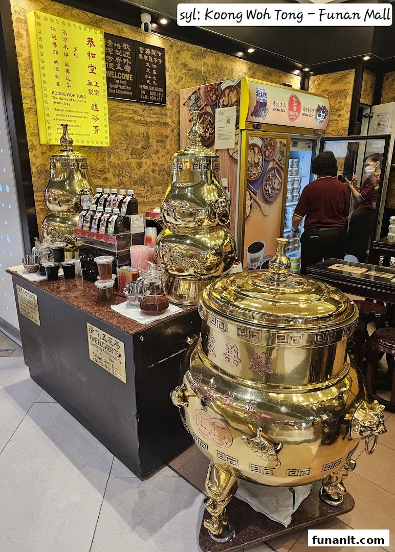 Interior view of Koong Woh Tong, showcasing traditional golden herbal tea dispensers and product displays.