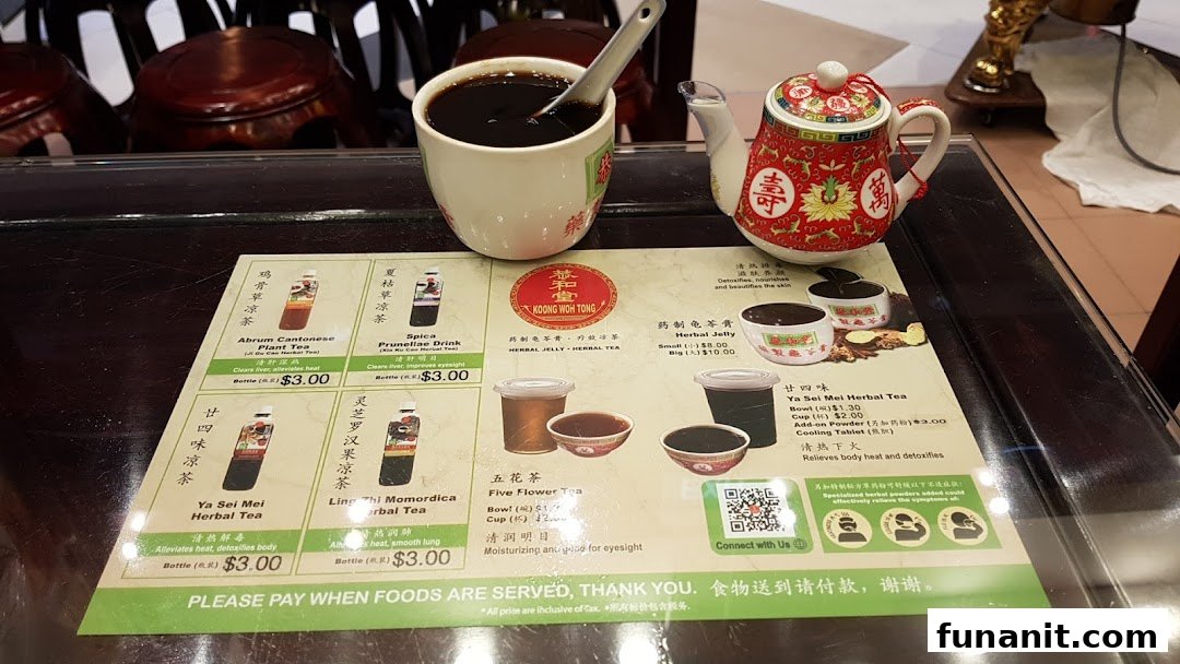 A menu display for Koong Woh Tong, featuring herbal teas and jelly, with a cup of herbal jelly and a teapot.