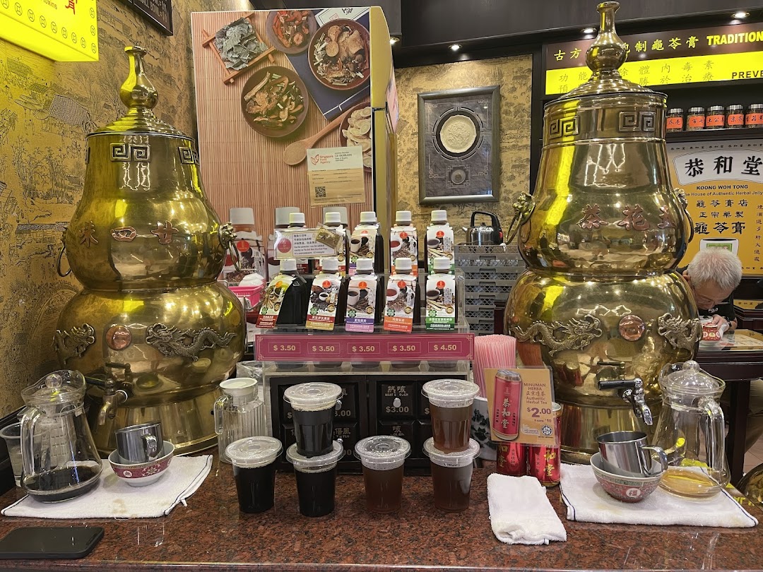 Traditional brass dispensers and various herbal remedies, including bottled drinks and jelly, are displayed at Koong Woh Tong.