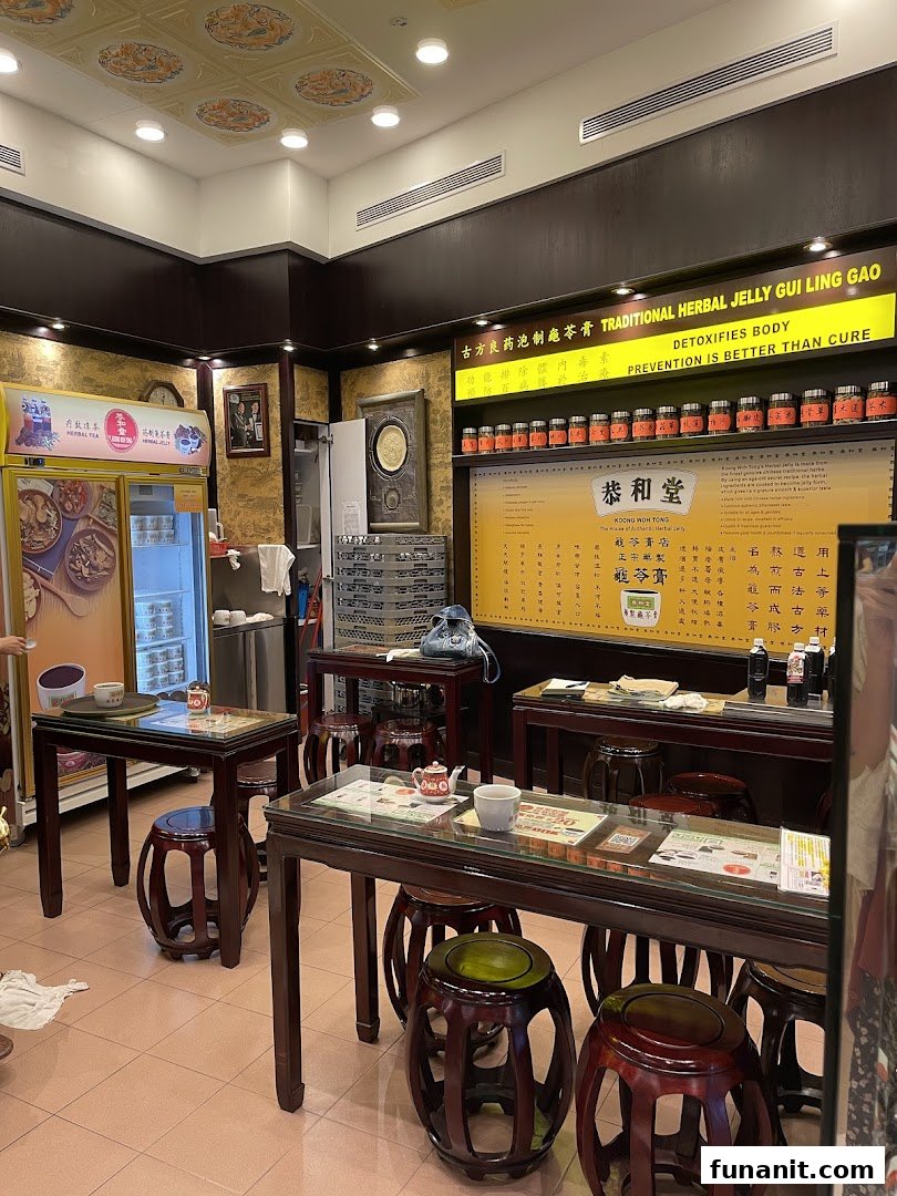 Interior view of Koong Woh Tong, a traditional herbal jelly shop, featuring seating, product displays, and a refrigerator.