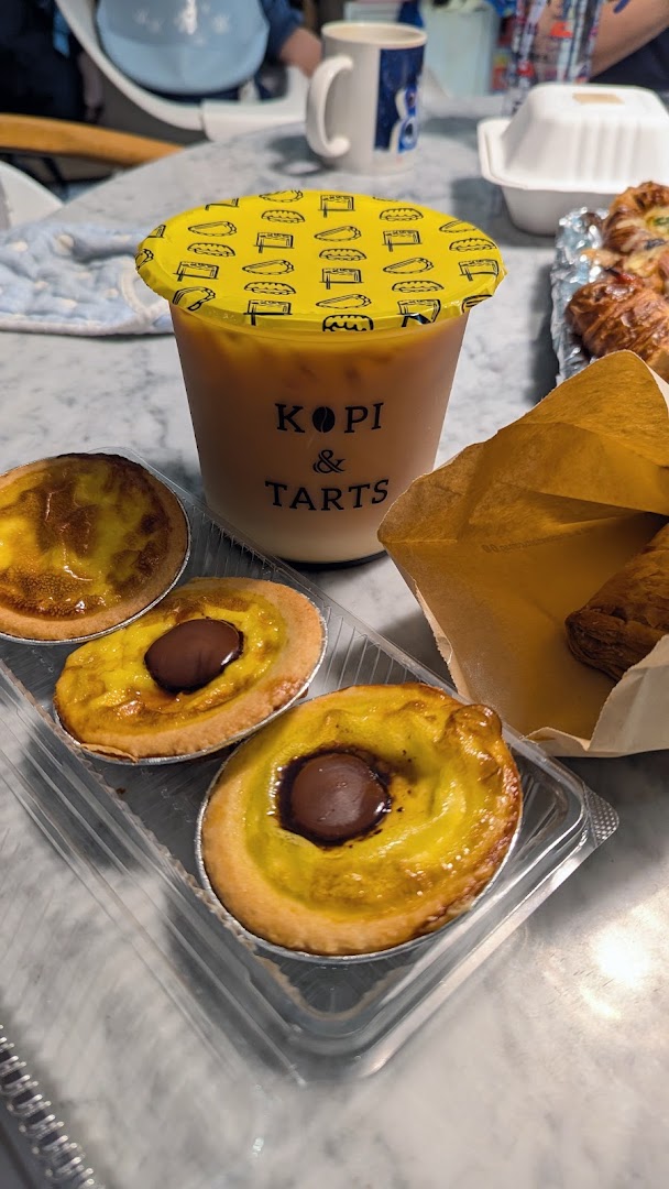 A refreshing iced coffee and a selection of delicious tarts, including chocolate-filled ones, from Kopi & Tarts.