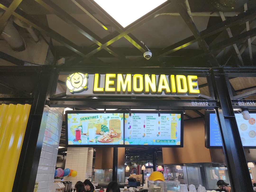 Digital menu boards display a variety of refreshing drinks and hot food options at Lemonaide.
