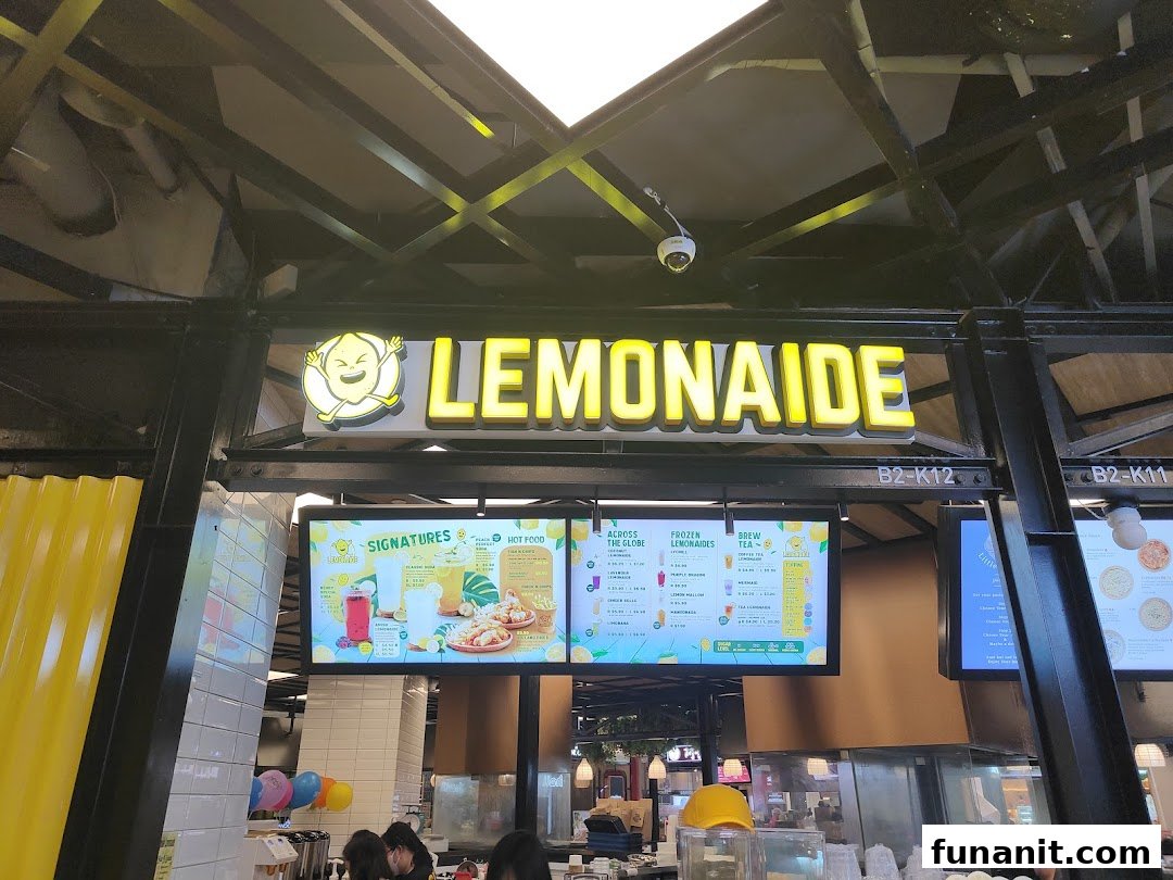 Digital menu boards display a variety of refreshing drinks and hot food options at Lemonaide.